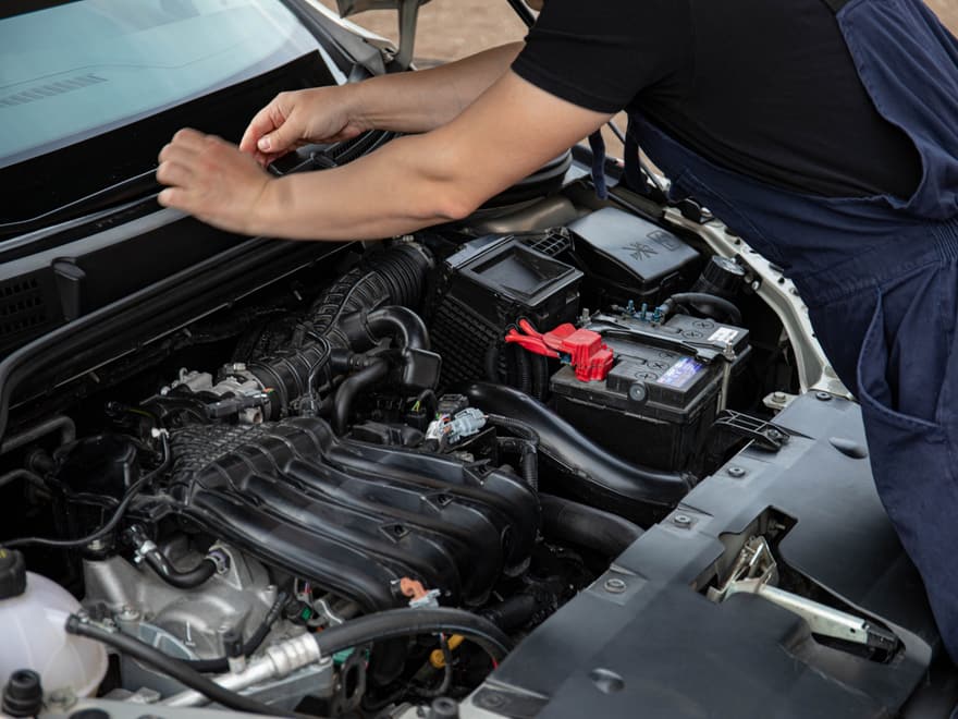Mechanic working under the bonnet of a car